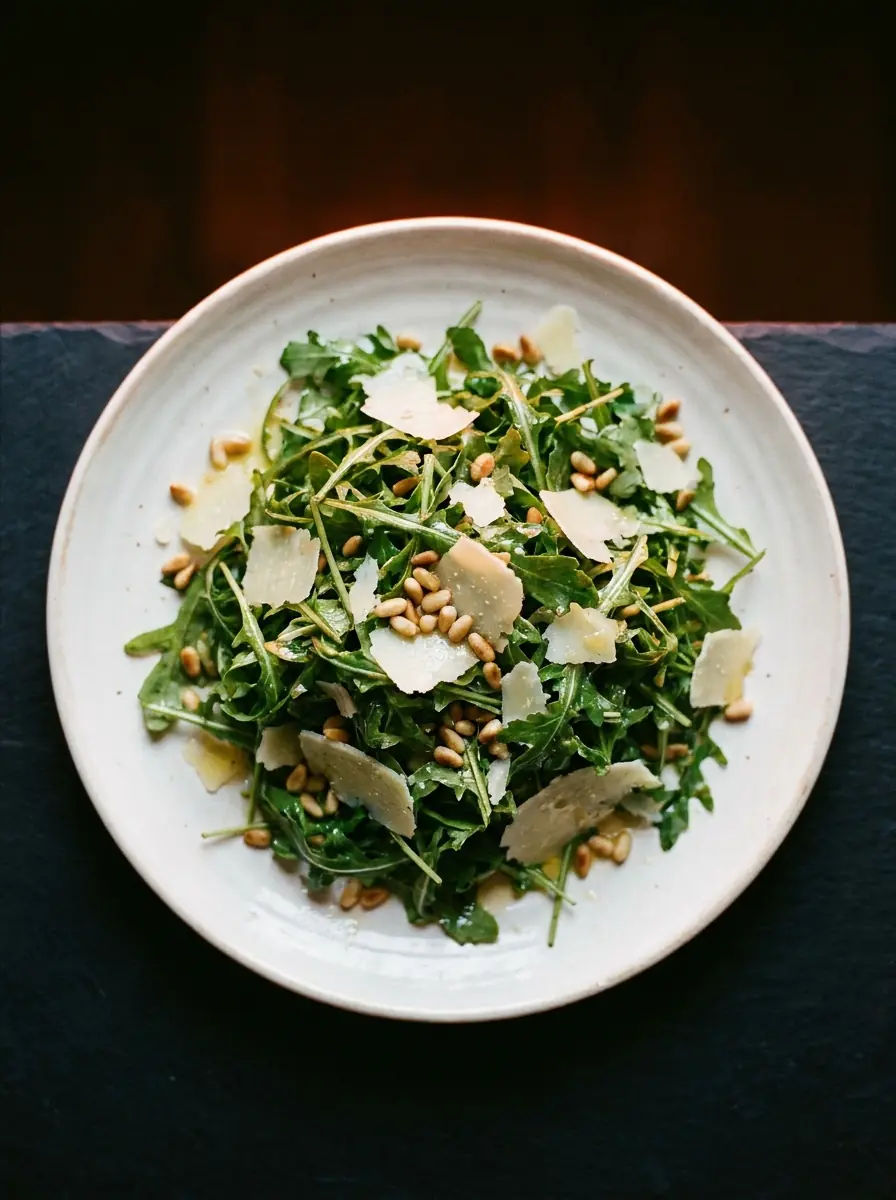 Rocket and parmesan salad on a white plate